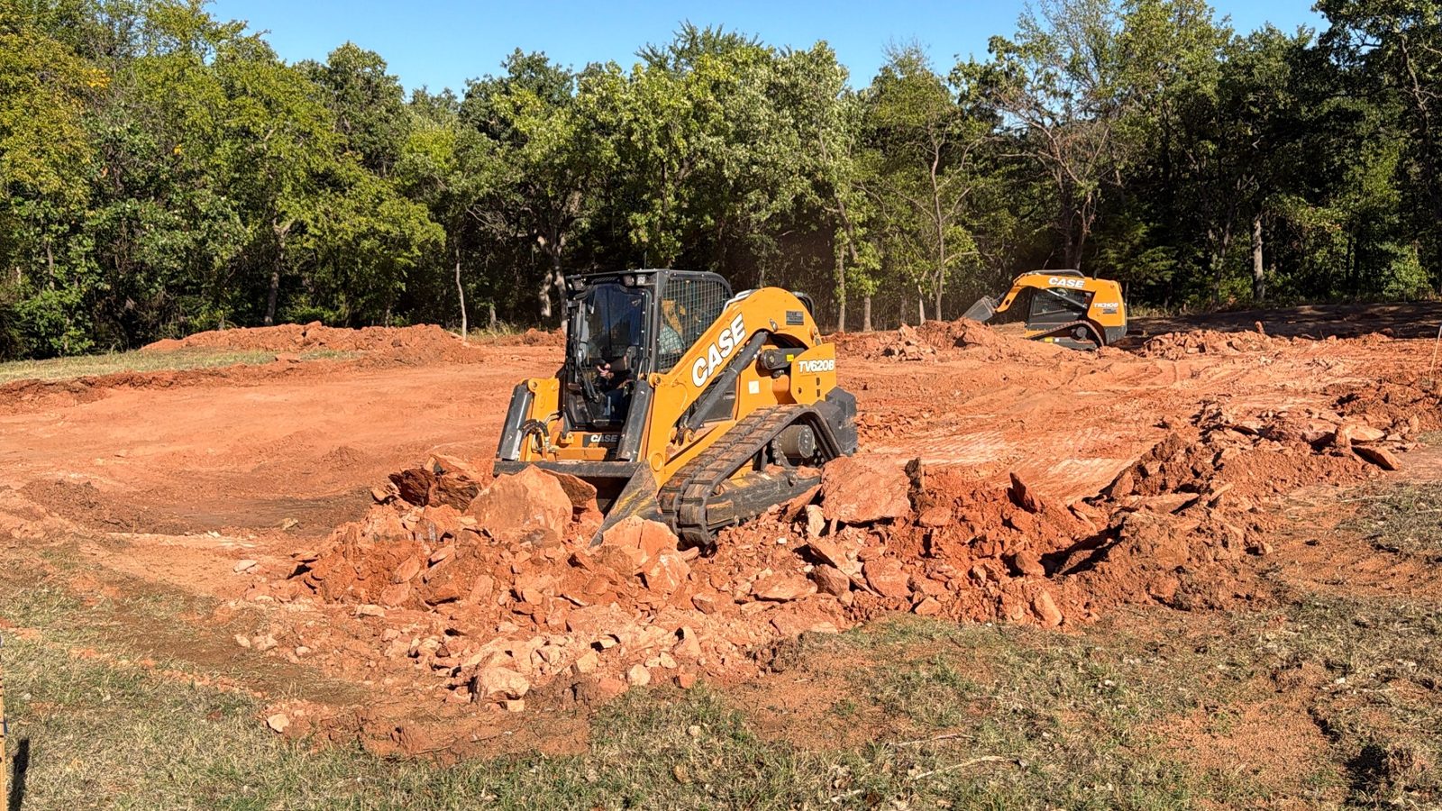 Track loader digging out rock to prepare a building lot