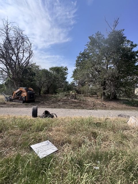 Lot cleanup with debris being gathered for haul off