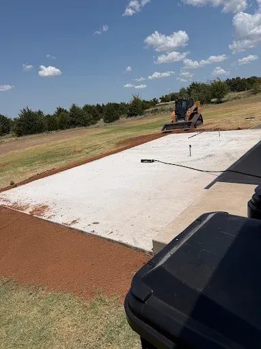 Finished concrete pad with graded and compacted approach